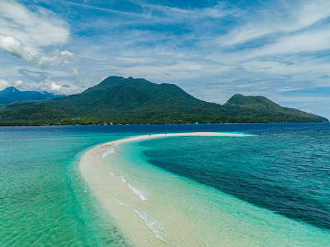 Seascape with white sandbar with turquoise ocean waves. White Island. Camiguin. Philippines.