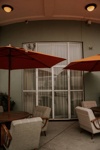istock Beautiful big windows with chairs around and with orange umbrellas - restaurant 1742326062
