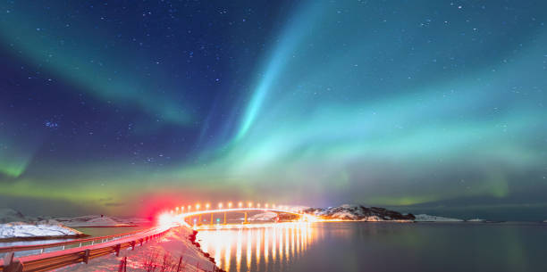 Sommaroy Bridge is a cantilever bridge connecting the islands of Kvaloya and Sommaroy with Aurora Borealis - Hillesoy Tromso Norway Sommaroy Bridge is a cantilever bridge connecting the islands of Kvaloya and Sommaroy with Aurora Borealis - Hillesoy Tromso Norway sommaroy stock pictures, royalty-free photos & images