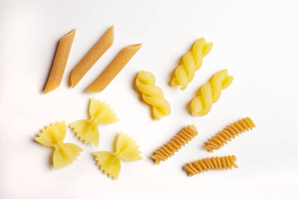 istock raw durum wheat and wholemeal pasta on a white background with a view from above 1742353476