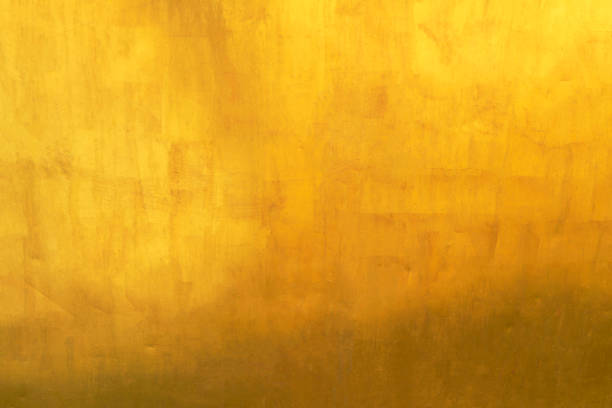 istock Old glod metal wall background or texture and shadow 1742360774