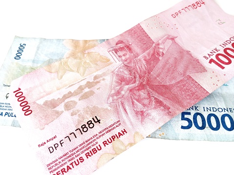 Photo of women dancing on Indonesian banknotes