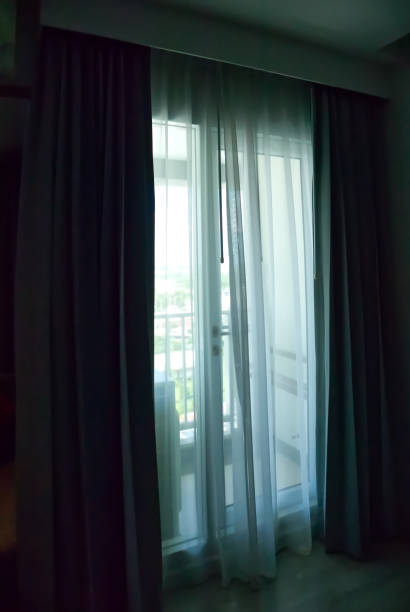 istock A window with natural light streaming in through the curtains, nature background 1742365811