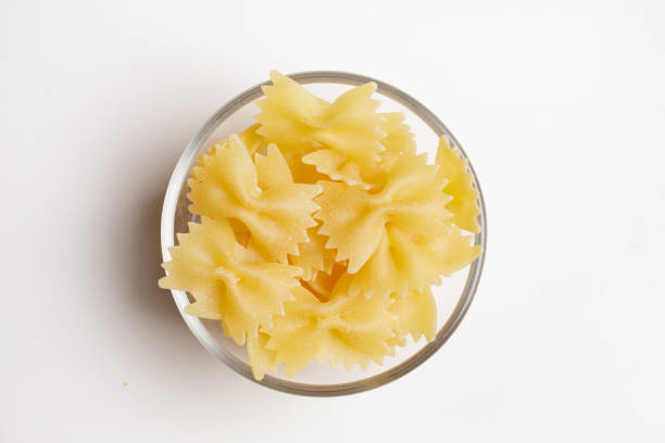 istock durum wheat pasta in glass bowl on white background viewed from above 1742366385