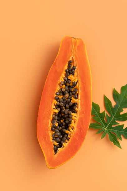 istock Cut Papaya over orange table background for tropical fruit design concept. 1742376906