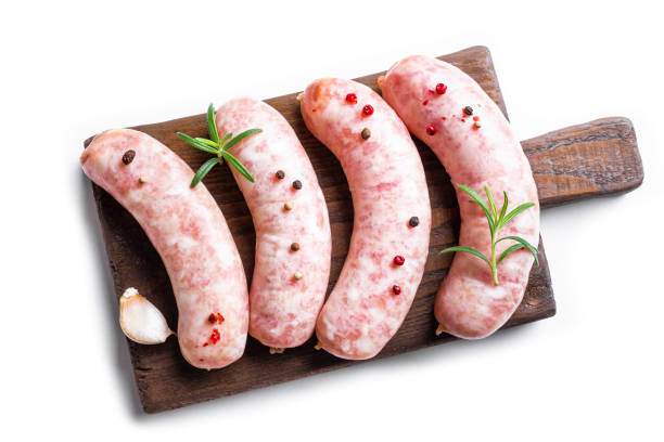 istock Raw Sausages with rosemary on wooden board 1742383234