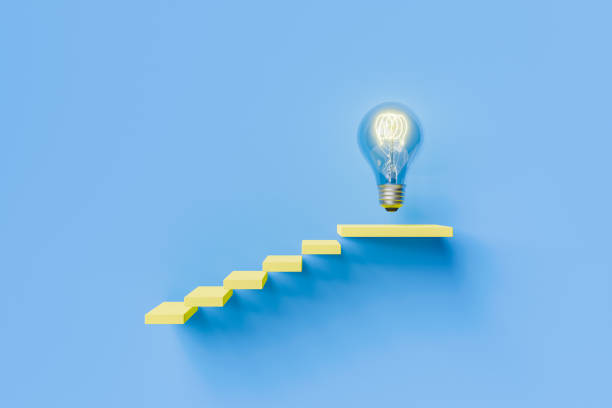 istock Conceptual image of stairs leading to light bulb on blue background 1742384332