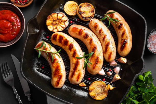 istock Grilled sausages with sauce and herbs 1742386603