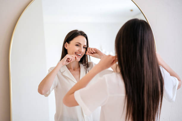 istock hapy female brushing teeth with dental floss 1742387695