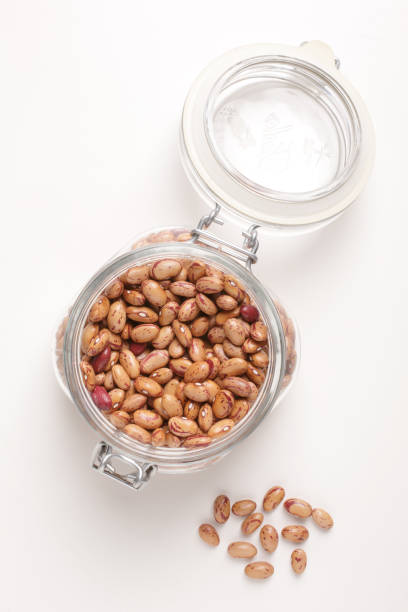istock borlotti beans inside a glass jar on a white background with a top view 1742392940