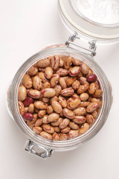 istock borlotti beans inside a glass jar on a white background with a top view 1742394041