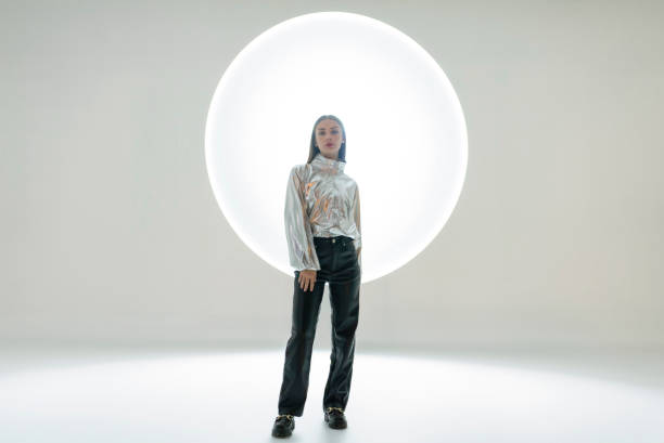 istock Young woman in front of a circular light shape 1742405454