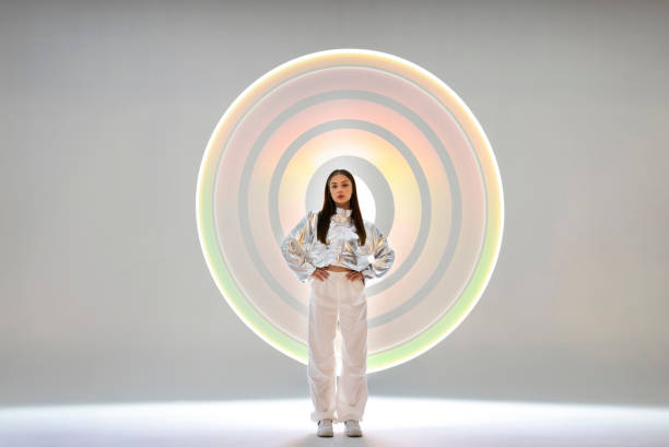 istock Young woman in front of a circular light shape 1742405457