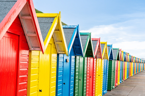 Pretty beach huts in Whitby, Yorkshire seen in September 2023