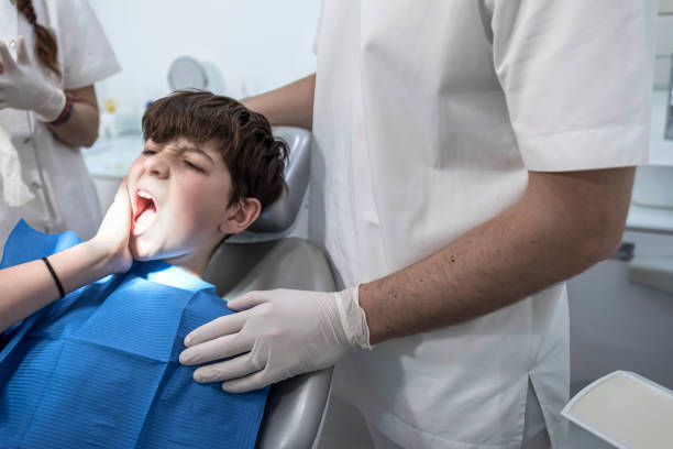 istock little boy with teeth pain looking sadness on his dentist 1742429778