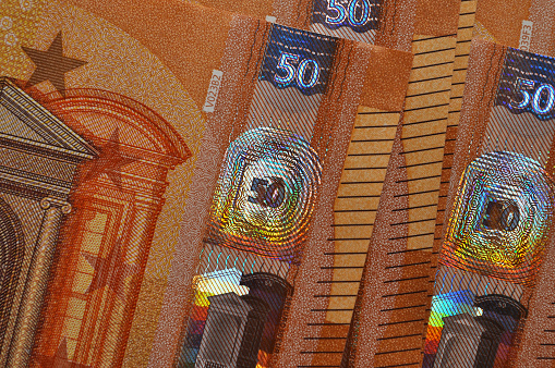 European 50 fifty euros banknotes with holograms closeup, abstract background