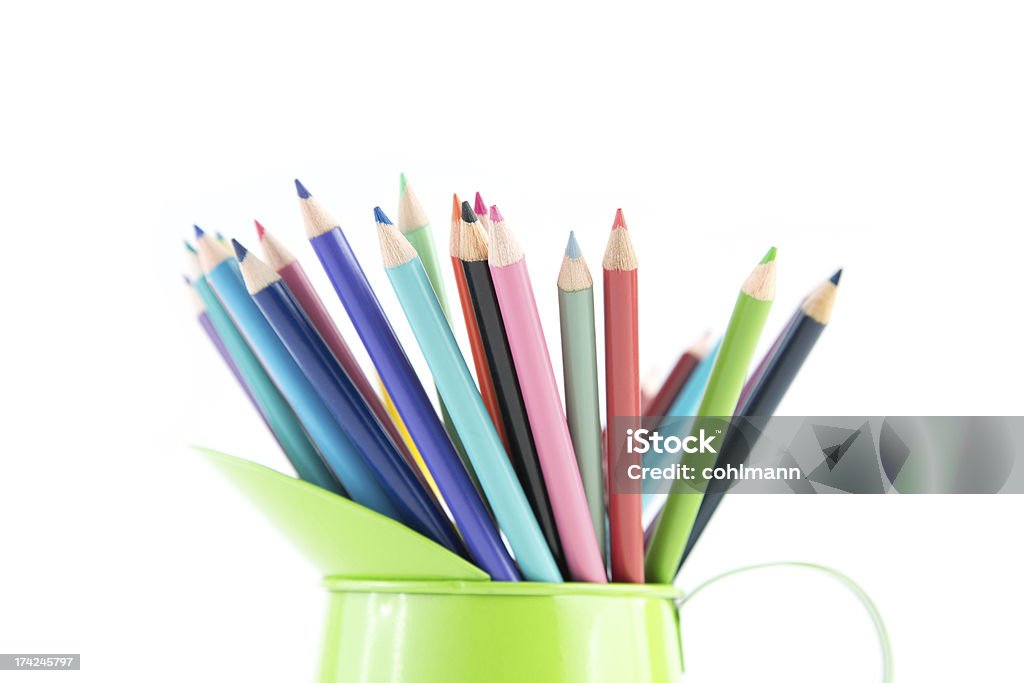 Color pencils in Green Cup Group of colorful pencil crayons in green metal pitcher isolated on white background Abstract Stock Photo