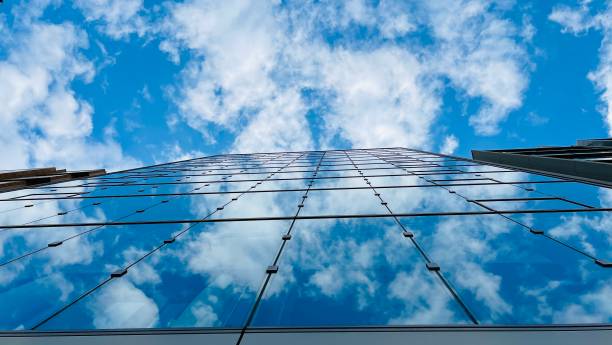 istock Looking up tall glass and steel high rise. Cloudy sky 1742468931