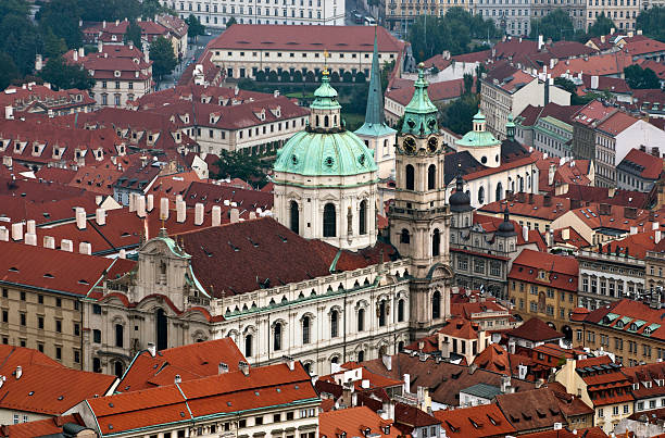 Prague - Saint Nicholas church Czech republic, prague - Saint Nicolas church and rooftops of Lesser Town st nicholas church prague stock pictures, royalty-free photos & images