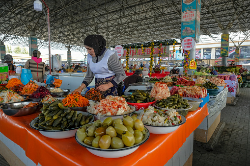 Fergana, Uzbekistan - October 18, 2023: A pickle seller at the City Market in Fergana, Uzbekistan.