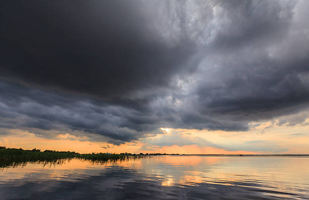 istock Beautiful storm clouds over lake in spring 174248089