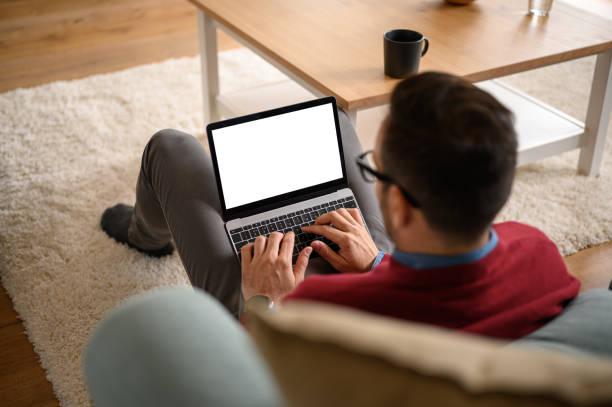 istock High angle view of businessman working over wireless computer while sitting on carpet in home office 1742481143