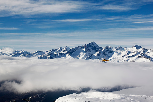 Aerial view of the Italian Alps in winter with snow and clouds. Madonna di Campiglio, Italy