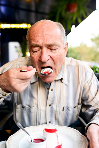 istock Senior Man Eating Panna Cotta Dessert in a restaurant 174249067