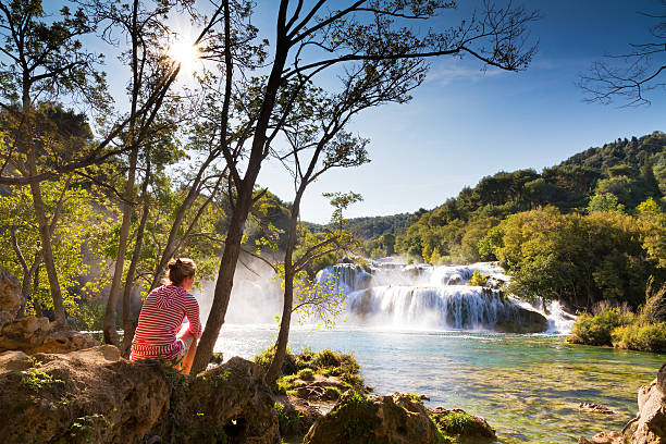 istock Woman at the waterfalls 174250547