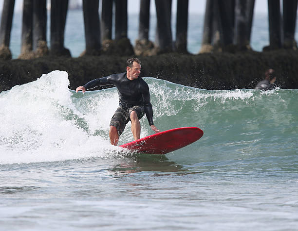 istock Surfer Catching a Wave by the Pier 174251258