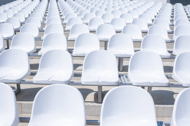 Rows of white plastic chairs are displayed on the street for the audience of the festive concert