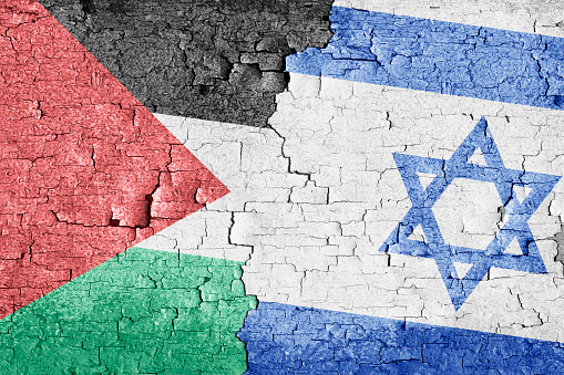 Israel and Palestine flags together on old cracked wall texture