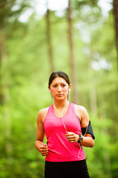 istock Pretty Young Woman jogging in park 174252178