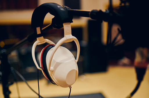White headphones in a recording studio.