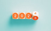 2023 And 2024 Written Orange Cubes On Teal Background