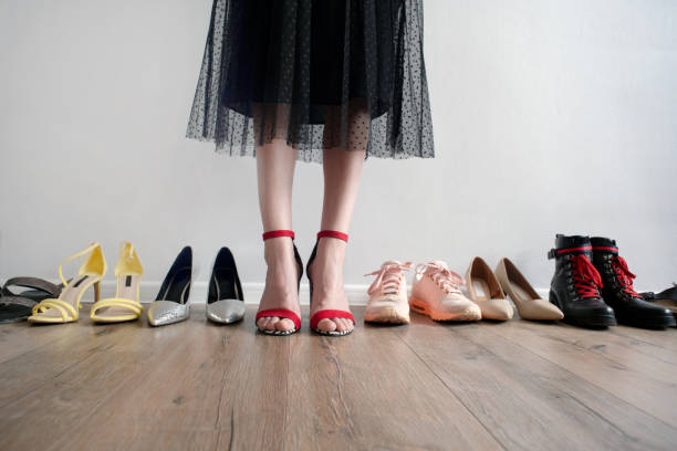 istock Woman chooses shoes from wardrobe shelf 1742541767