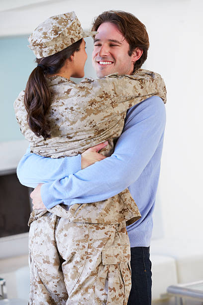 istock Husband Greeting Military Wife Home On Leave 174254911