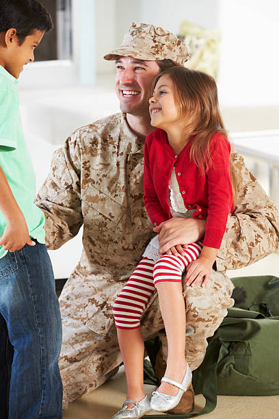 istock Children Greeting Military Father Home On Leave 174255321