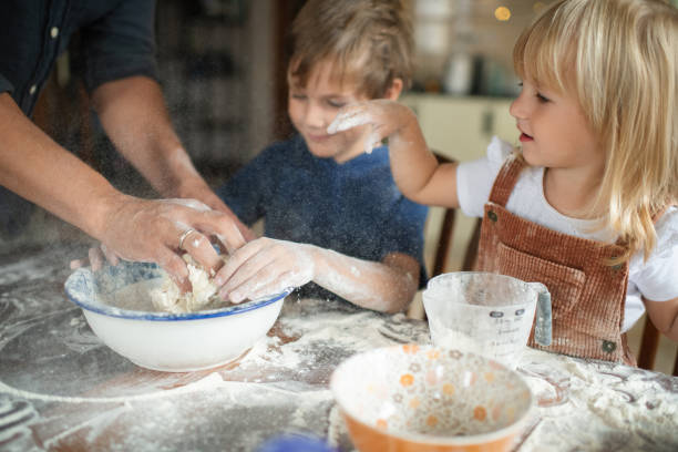 istock Family making dough for a cake , cookies or pizza at the kitchen 1742559233
