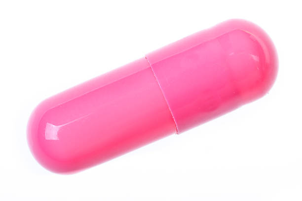 cápsula de color rosado - pink pill fotografías e imágenes de stock