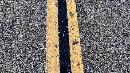 Line of highway road markings, on the highway that crosses the Mojave Desert from Los Angeles in California, to Las Vegas in Nevada.
