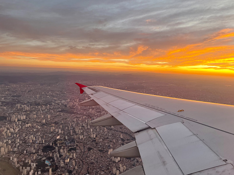 view from the window of an airplane. turbine of an airplane under the Sao Paulo, Brazil. .At the sunset.