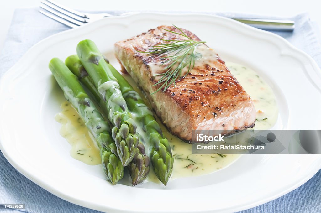 Salmon with Asparagus Grilled salmon with asparagus and dill sauce on white plate Salmon - Seafood Stock Photo