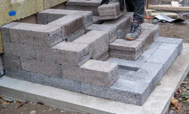 istock Worker building steps to entrance with light weight cinder blocks 1742599338