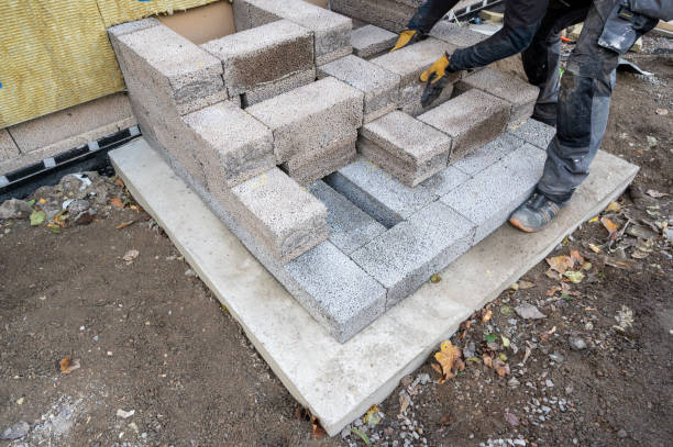 istock Worker building steps to entrance with light weight cinder blocks 1742599369