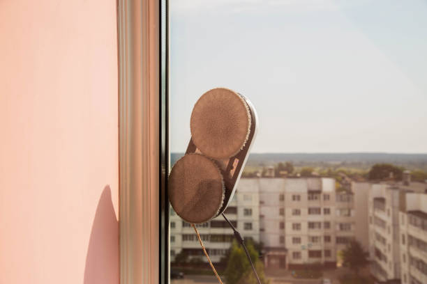 istock A modern vacuum robot window cleaner washes glass from dirt and stains on a pvc balcony frame. Fall safety. Copy space for text 1742611285