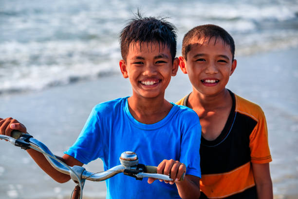 istock Vietnamese young boys riding a bicycle on the beach, Vietnam 1742612603
