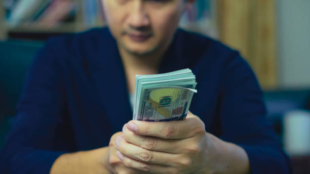 istock A man handing money benefits. 1742612623