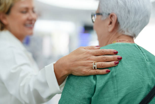 istock Pharmacist hand on senior customer shoulder 1742614440