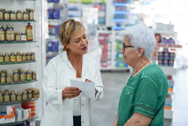 istock Senior customer showing prescription to pharmacist. 1742614489